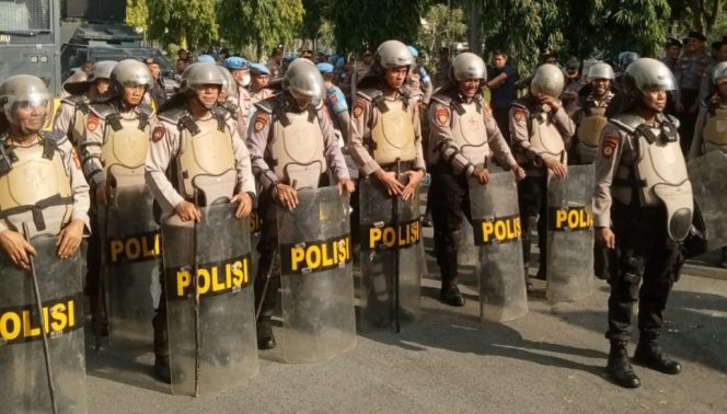
					Polisi garda terdepan menerima aksi massa tolak relokasi di kantor gubernur Riau.