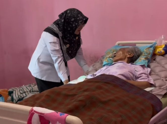 
					Bupati Siak, Afni saat menjenguk guru SD-nya, Ibu Salmiah. (Foto: ist)